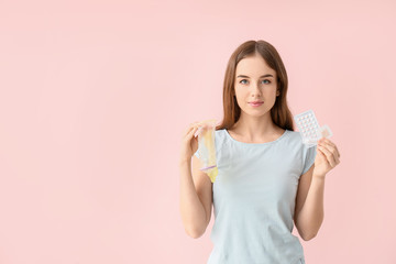 Sticker - Young woman with different means of contraception on color background