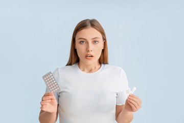 Sticker - Young woman with different contraceptive means on color background