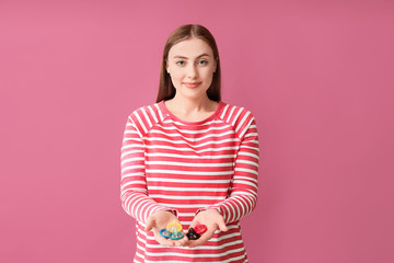 Sticker - Young woman with condoms on color background