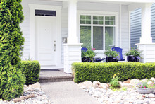 Beautiful New Contemporary White Home In A Canadian Neighbourhood. Front Door With A Pretty Porch And Rock Garden.
