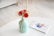 © Pixel-Shot - Vase with bouquet of beautiful flowers on table in room