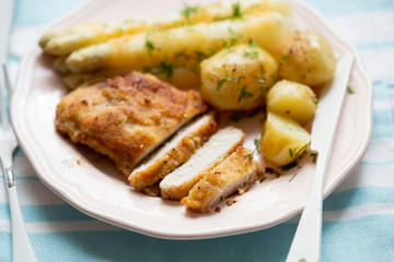 Wall Mural - Breaded pork chops (schabowy) with baby potatoes and white asparagus with dill 