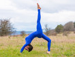 © Pelo Blanco Photo - Athletic woman doing yoga in a grass field.