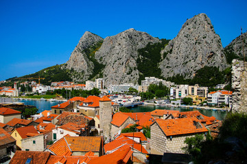 Wall Mural - Aerial view of the mouth of the Cetina River in Omis, Croatia - Old village by the mountains with a famous canyon