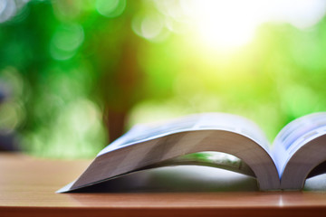 Open book on table on natural background and copy space