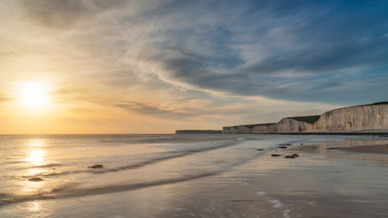 Wall Mural - Stunning landscape image of white chalk cliffs with colorful vibrant sunset on English coast