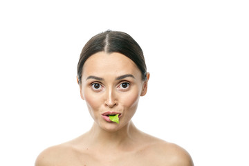 Wall Mural - portrait of a girl with clean skin without makeup with a leaf of green salad