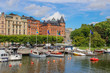 center of the Scandinavian capital of Stockholm with smooth bay water, promenade, yachts and houses. Scandinavian architecture of cities.