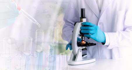 Wall Mural - laboratory concept; vintage style picture of scientist uses a microscope, with blurred of research a