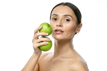 close-up portrait of a girl with clear skin holding a apple to her face, isolated on a white background