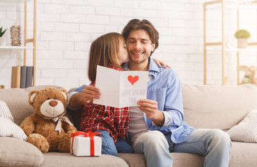 Wall Mural - Adorable preschool girl greeting her daddy at home