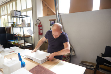 book binder working in a warehouse