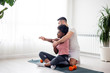 © pucko_ns - Multiethnic couple exercise at home early in the morning