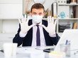 © JackF - Man in personal protective equipment working at office