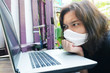 © cocorattanakorn - Asian Thai woman wearing a white cloth mask for prevent the Covid-19 or Corona virus and she serious work from home with laptop and problem working online system. Air Pollution Value Pm 2.5 concept.