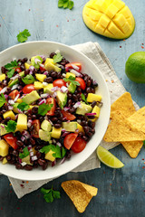 Wall Mural - Avocado, mango salad with black bean, tomato, red onion and tortilla chips. healthy food