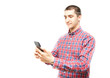 © Arthur Shevtsov - Young man in a plaid shirt with a smartphone on a white background. The guy looks at the smartphone and holds it in front of  him