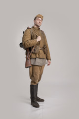 Wall Mural - Actor man in an old military uniform and camouflage clothing of a soldier of the Soviet army during the World War II