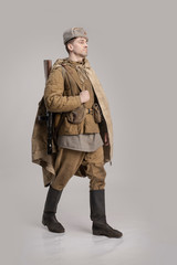 Wall Mural - Actor man in an old military uniform and camouflage clothing of a soldier of the Soviet army during the World War II