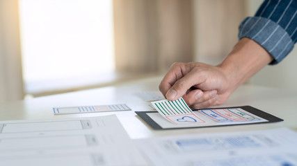 ux designer creative planning application development near layouts of mobile smartphone frameworks, User experience concept.