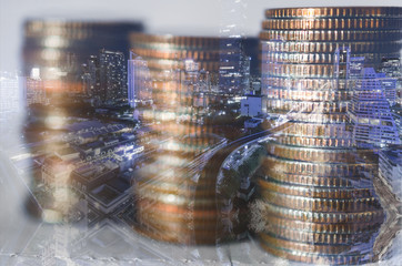 double exposure of city with row of coin stack with growth chart and graph progress report for business investment finance banking and money saving concept.