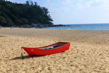 Wall Mural - Tropical landscape. Red wooden boat on a sandy beach.