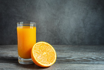 Glass of Fresh Orange Juice Fruit Extract on Wooden Table