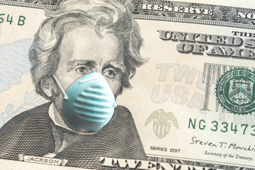 Close up of United States paper currency twenty dollar bill with Andrew Jackson wearing blue face covering mask due to COVID-19 pandemic making a great finance or economic background amidst the crisis