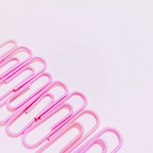 High Angle V9iew Of Paper Clips On Pink Background