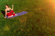 ©  drugoenebo - A young girl is engaged in stretching in the fresh air. The body of an athlete without a face on a yoga mat