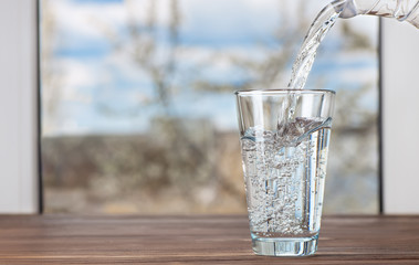 Canvas Print - water pouring from jug into glass