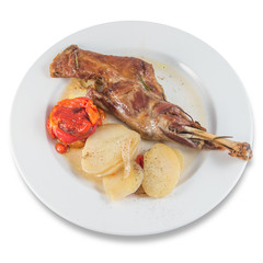 Baked leg of goat, with baked potatoes and roasted red peppers.