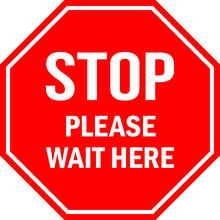 STOP Please Wait Here Sign. Red Octagonal Background. Social Distancing Floor Sign Tells Visitors Or Workers To Wait.