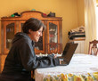 © Arturo - smiling woman doing home office