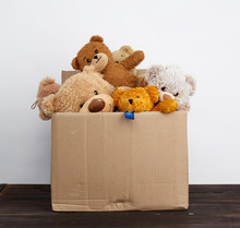 Brown Cardboard Box Filled With Soft Toys