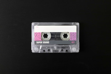 Old tape cassette, old or aged wood background. İsolated casette