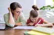 © Valerii Honcharuk - Mother and daughter child study together at home
