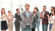 © ASDF - smiling entrepreneur on the background of jubilant business team
