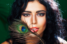 Young Sensitive Brunette Woman With Peacock Feather Eyes Closeup On Green Smiling, Lifestyle People Concept Macro