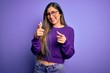 © Krakenimages.com - Young beautiful smart woman wearing glasses over purple isolated background pointing fingers to camera with happy and funny face. Good energy and vibes.