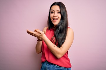 Young brunette woman wearing casual summer shirt over pink isolated background clapping and applauding happy and joyful, smiling proud hands together