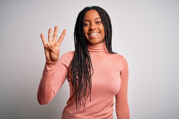 Young african american woman standing casual and cool over white isolated background showing and pointing up with fingers number four while smiling confident and happy.