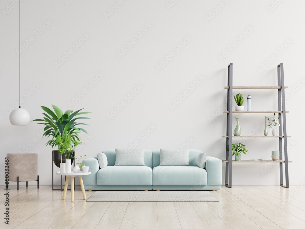 Empty living room with blue sofa, plants and table on empty white wall background. - obrazy, fototapety, plakaty 