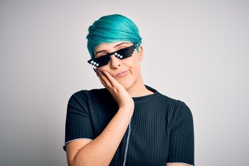 Sticker - Young woman with blue fashion hair wearing thug life sunglasses over white background thinking looking tired and bored with depression problems with crossed arms.