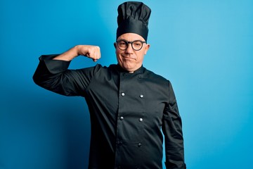 Sticker - Middle age handsome grey-haired chef man wearing cooker uniform and hat Strong person showing arm muscle, confident and proud of power