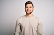 © Krakenimages.com - Young handsome blond man with beard and blue eyes wearing casual sweater with a happy and cool smile on face. Lucky person.