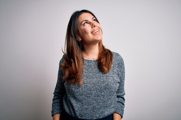 Poster - Young beautiful brunette woman smiling happy and confident. Standing with smile on face wearing casual sweater over isolated white background