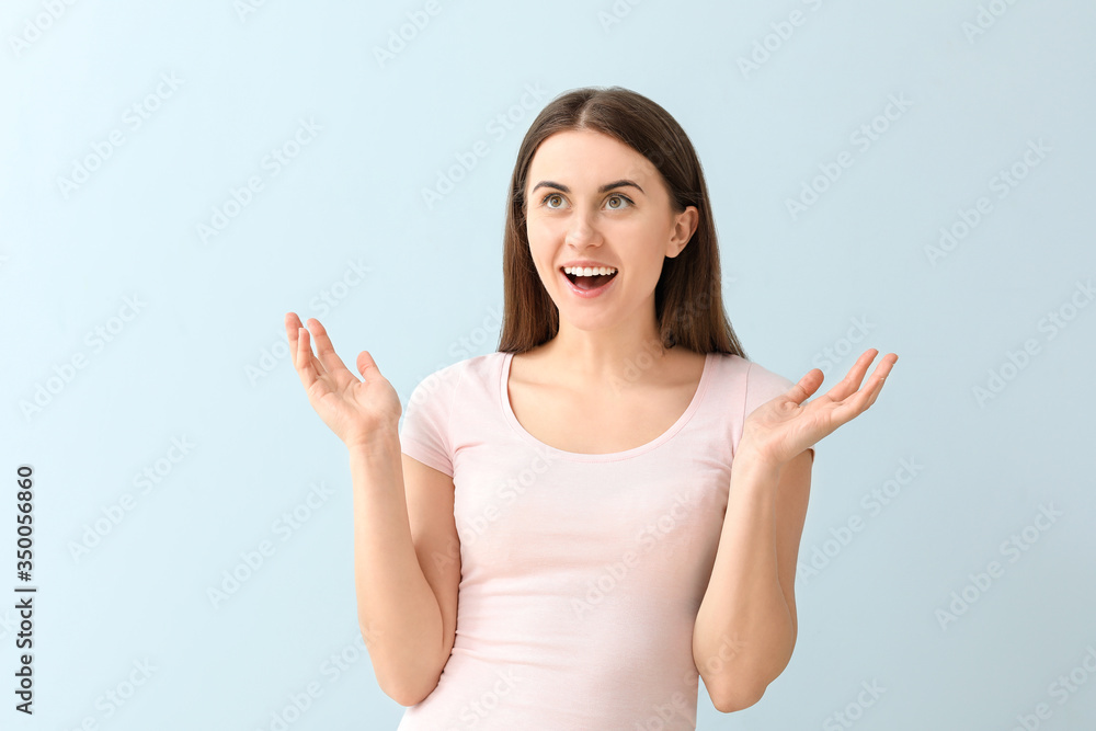 Happy young woman on color background