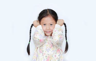 Wall Mural - Adorable little Asian child girl holding pigtail on white background. Portrait of children with two pigtails.