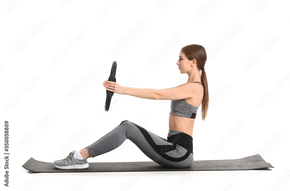 Sporty young woman training against white background